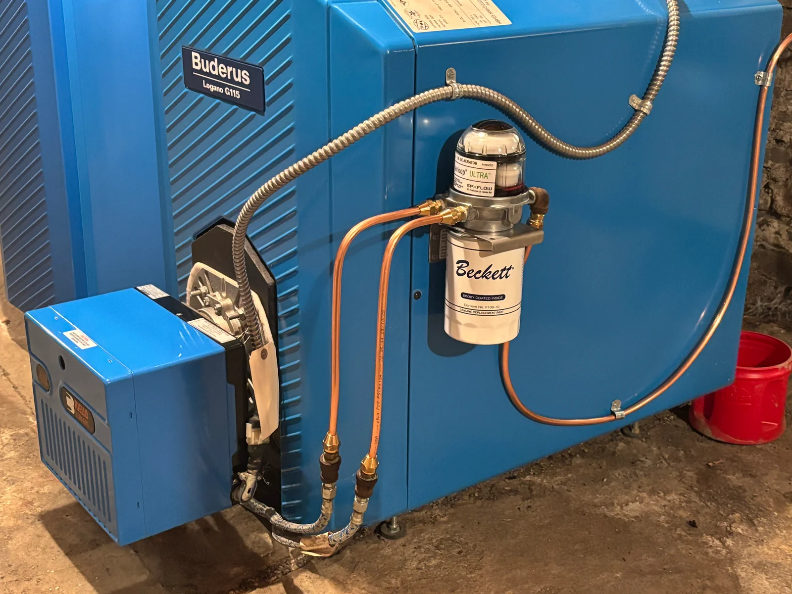 Buderus boiler with Beckett RPZ backflow preventer, copper piping, and brass fittings installed