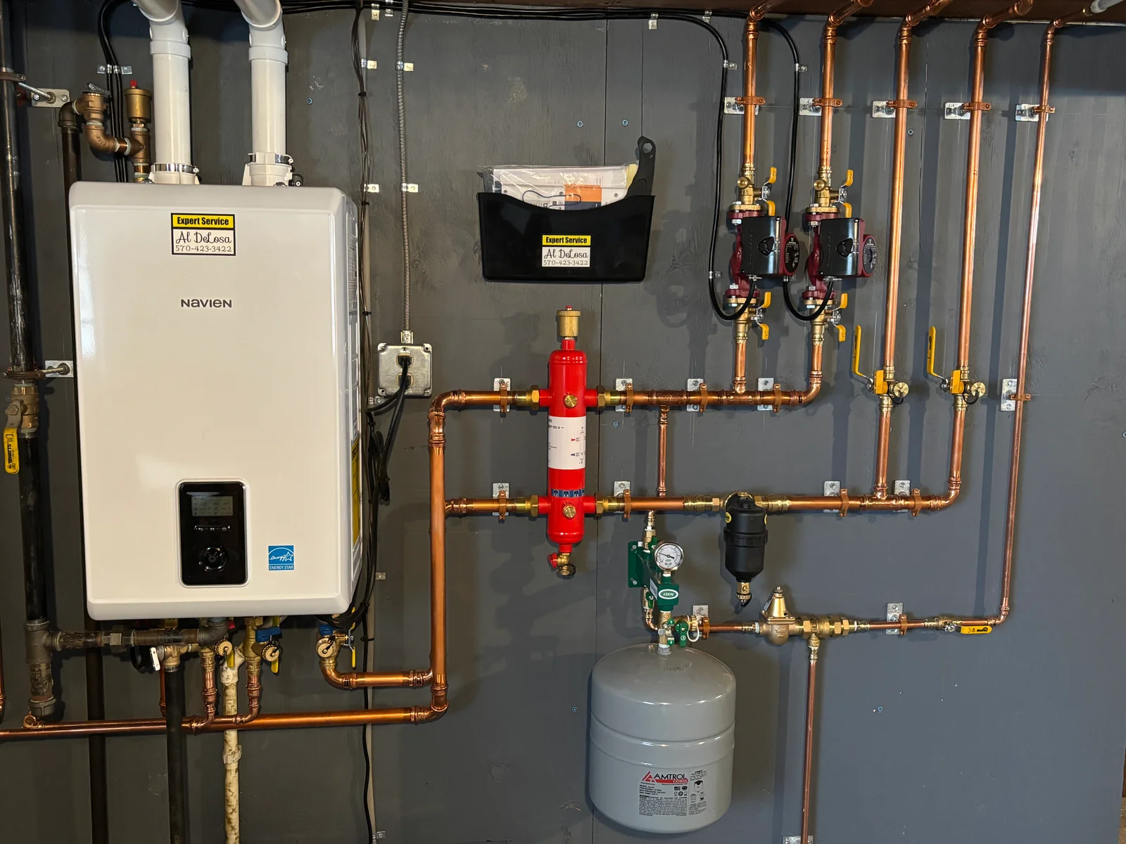 Navien water heater with copper piping, dual RPP backflow preventers, red ball valves, and expansion tank