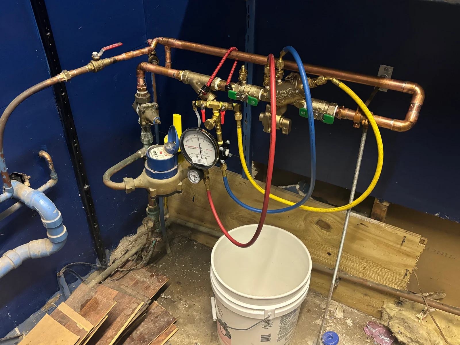 Copper backflow prevention assembly with brass fittings, gauges, and color-coded ball valves